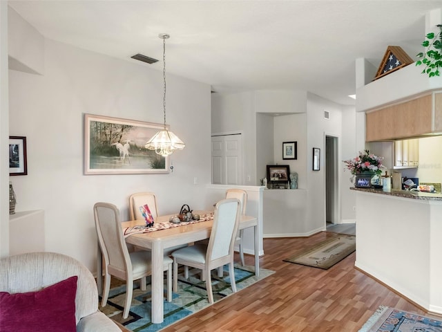 4814 Saint Andrews Arc, Leesburg, FL 34748 - dining room featuring wood finished floors and a chandelier