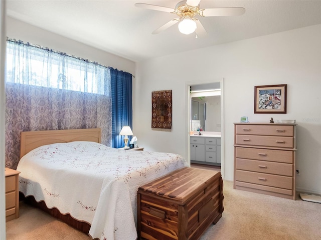 4814 Saint Andrews Arc, Leesburg, FL 34748 - bedroom featuring light colored carpet, ensuite bath, and a ceiling fan