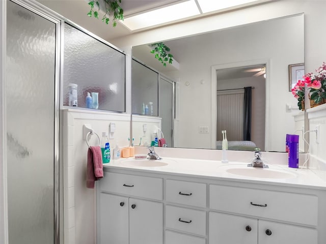 4814 Saint Andrews Arc, Leesburg, FL 34748 - full bathroom featuring double vanity, a shower stall, and a ceiling fan