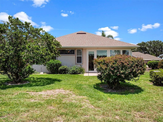 4814 Saint Andrews Arc, Leesburg, FL 34748 - view of front of house featuring a front yard, a shingled roof, and stucco siding