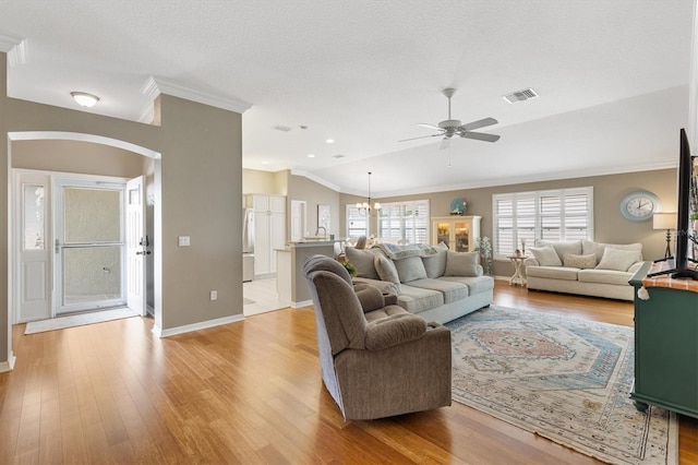 2465 Violet Ct, The Villages, FL 32162 - living area featuring a ceiling fan, crown molding, light wood-type flooring, arched walkways, and a chandelier