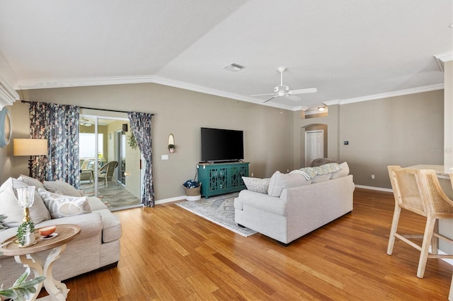 2465 Violet Ct, The Villages, FL 32162 - living room featuring light wood finished floors, arched walkways, ceiling fan, crown molding, and lofted ceiling