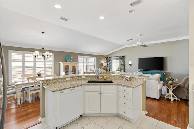 2465 Violet Ct, The Villages, FL 32162 - kitchen with white dishwasher, open floor plan, ornamental molding, light stone countertops, and lofted ceiling