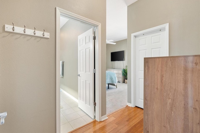 2465 Violet Ct, The Villages, FL 32162 - hallway featuring light wood-type flooring and baseboards