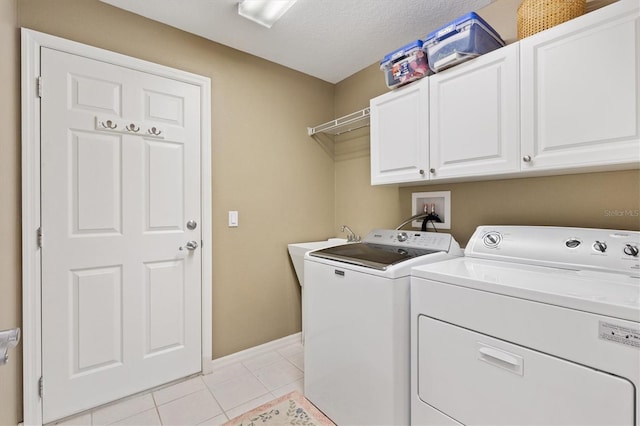 2465 Violet Ct, The Villages, FL 32162 - washroom featuring washing machine and dryer, cabinet space, and light tile patterned floors