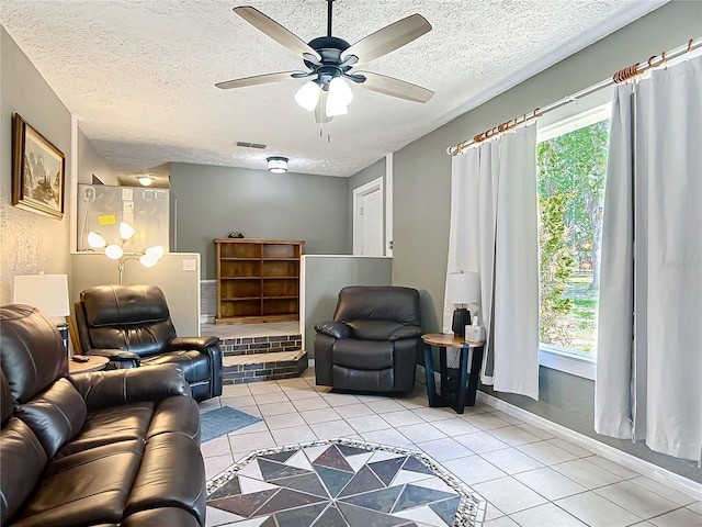 45 Forest Ln, Bronson, FL 32621 - living area with light tile patterned floors, plenty of natural light, a textured ceiling, and ceiling fan