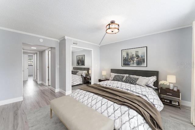 101 N Grandview St Unit 205, Mount Dora, FL 32757 - bedroom featuring wood finished floors, crown molding, and a textured ceiling