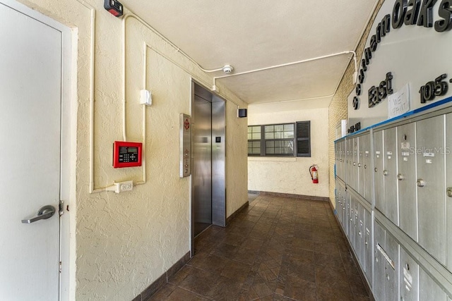 101 N Grandview St Unit 205, Mount Dora, FL 32757 - hall featuring a textured wall, elevator, and mail area