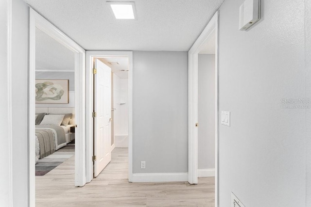 101 N Grandview St Unit 205, Mount Dora, FL 32757 - hall featuring light wood-type flooring and a textured ceiling