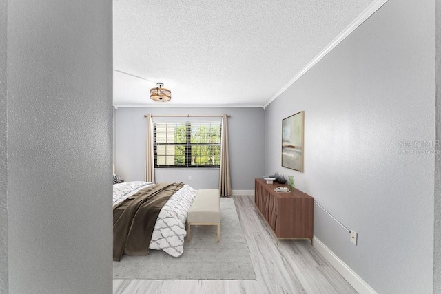 101 N Grandview St Unit 205, Mount Dora, FL 32757 - bedroom featuring crown molding, light wood-type flooring, and a textured ceiling