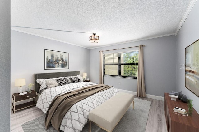 101 N Grandview St Unit 205, Mount Dora, FL 32757 - bedroom with crown molding, light wood finished floors, and a textured ceiling