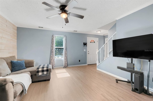 323 Savage Way, Groveland, FL 34736 - living area featuring wood finished floors, ceiling fan, a textured ceiling, crown molding, and stairway