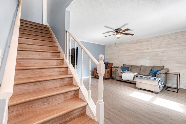 323 Savage Way, Groveland, FL 34736 - stairway with ceiling fan, wood finished floors, a textured ceiling, and crown molding
