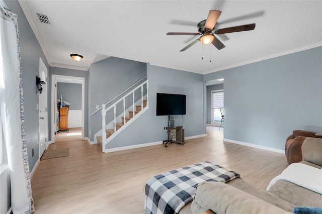 323 Savage Way, Groveland, FL 34736 - living area with stairs, light wood-style flooring, crown molding, and a ceiling fan