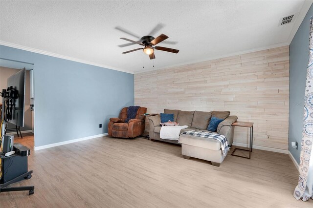323 Savage Way, Groveland, FL 34736 - living area with ceiling fan, ornamental molding, wood finished floors, wood walls, and a textured ceiling