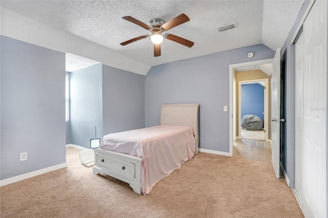 323 Savage Way, Groveland, FL 34736 - bedroom featuring light colored carpet, a textured ceiling, a closet, vaulted ceiling, and ceiling fan