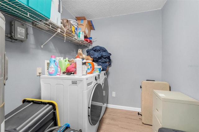 323 Savage Way, Groveland, FL 34736 - washroom with washer and dryer, light wood-type flooring, and a textured ceiling