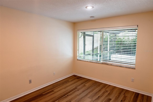 681 Greywood Dr, Altamonte Springs, FL 32701 - spare room featuring a textured ceiling, wood finished floors, and a smoke detector