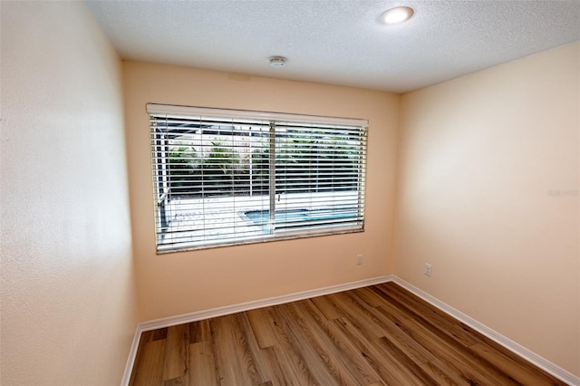 681 Greywood Dr, Altamonte Springs, FL 32701 - unfurnished room featuring wood finished floors, a textured ceiling, and a smoke detector