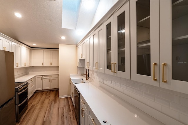 681 Greywood Dr, Altamonte Springs, FL 32701 - kitchen with stainless steel appliances, wood finished floors, backsplash, glass insert cabinets, and recessed lighting