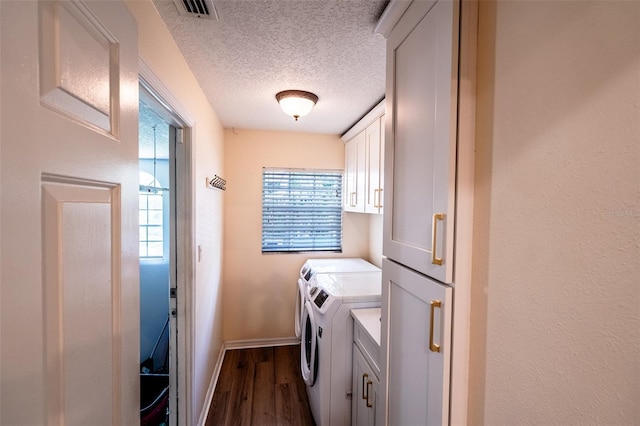681 Greywood Dr, Altamonte Springs, FL 32701 - laundry room featuring cabinet space, washer and dryer, dark wood finished floors, and a textured ceiling