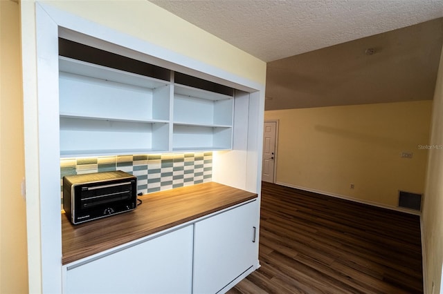 681 Greywood Dr, Altamonte Springs, FL 32701 - kitchen with a textured ceiling, dark wood-style flooring, white cabinets, and wood counters