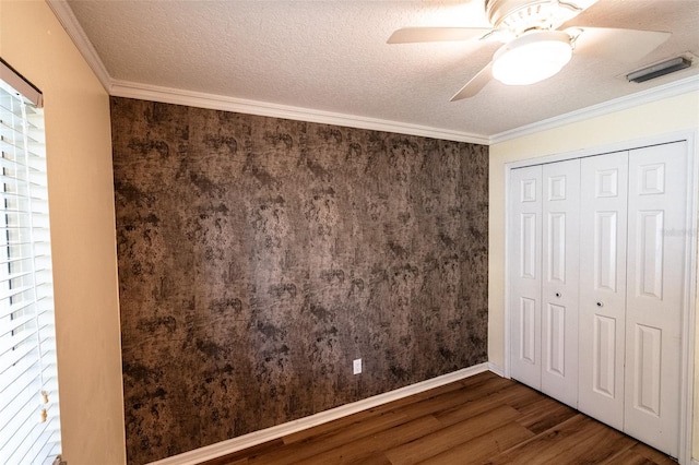 681 Greywood Dr, Altamonte Springs, FL 32701 - unfurnished bedroom with wood finished floors, a closet, crown molding, a ceiling fan, and a textured ceiling