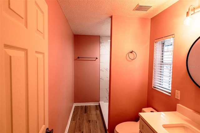 681 Greywood Dr, Altamonte Springs, FL 32701 - full bath with vanity, a shower, wood finished floors, and a textured ceiling