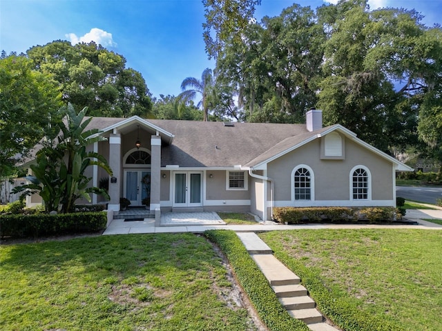 681 Greywood Dr, Altamonte Springs, FL 32701 - view of front of home featuring french doors, a chimney, a front yard, and stucco siding
