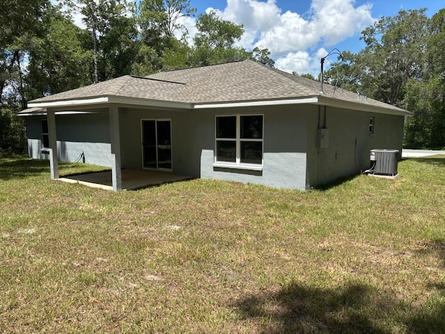 1176 W Bridge Dr, Citrus Springs, FL 34434 - back of property featuring stucco siding, a yard, roof with shingles, and a patio