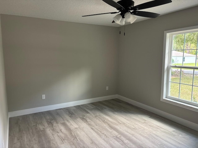 1176 W Bridge Dr, Citrus Springs, FL 34434 - unfurnished room with wood finished floors, a ceiling fan, and a textured ceiling