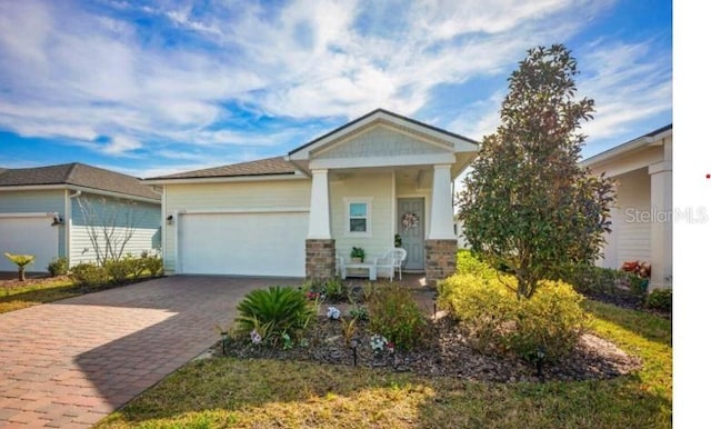 1055 Rustic Mill Dr, Saint Augustine, FL 32092 - view of front of home featuring a garage and decorative driveway