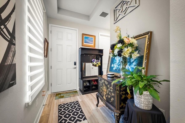 1055 Rustic Mill Dr, Saint Augustine, FL 32092 - entrance foyer with wood finished floors, a tray ceiling, and a textured wall