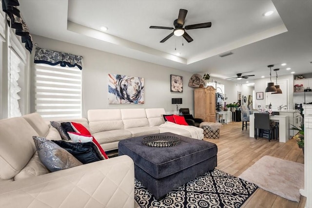 1055 Rustic Mill Dr, Saint Augustine, FL 32092 - living room featuring a ceiling fan, light wood-type flooring, a tray ceiling, and recessed lighting