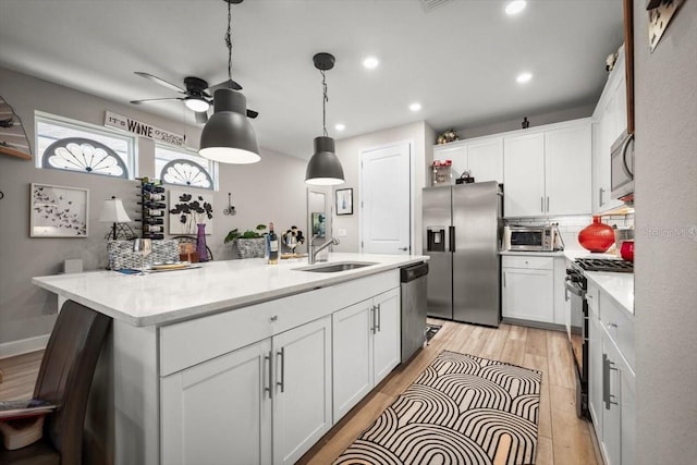 1055 Rustic Mill Dr, Saint Augustine, FL 32092 - kitchen with appliances with stainless steel finishes, a ceiling fan, white cabinetry, light countertops, and recessed lighting