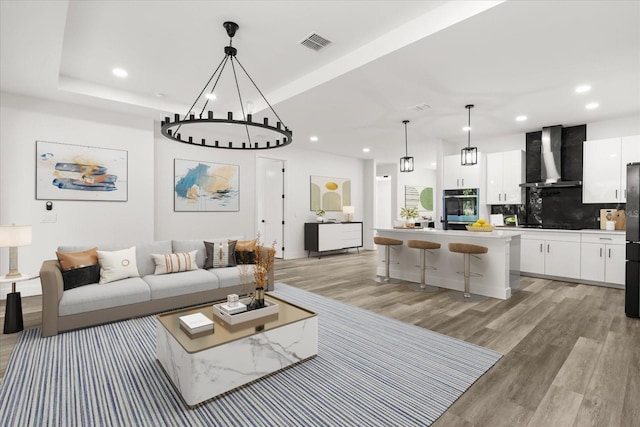 321 Watershore Dr, Leesburg, FL 34748 - living area with recessed lighting, light wood-style flooring, and a chandelier