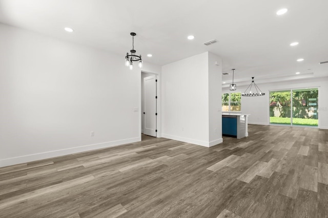 321 Watershore Dr, Leesburg, FL 34748 - unfurnished living room featuring a chandelier, recessed lighting, and wood finished floors