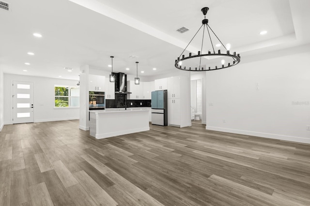 321 Watershore Dr, Leesburg, FL 34748 - kitchen featuring freestanding refrigerator, oven, open floor plan, recessed lighting, and wall chimney exhaust hood