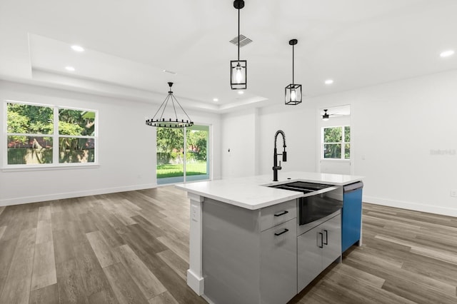321 Watershore Dr, Leesburg, FL 34748 - kitchen with a raised ceiling, recessed lighting, modern cabinets, dishwashing machine, and wood finished floors