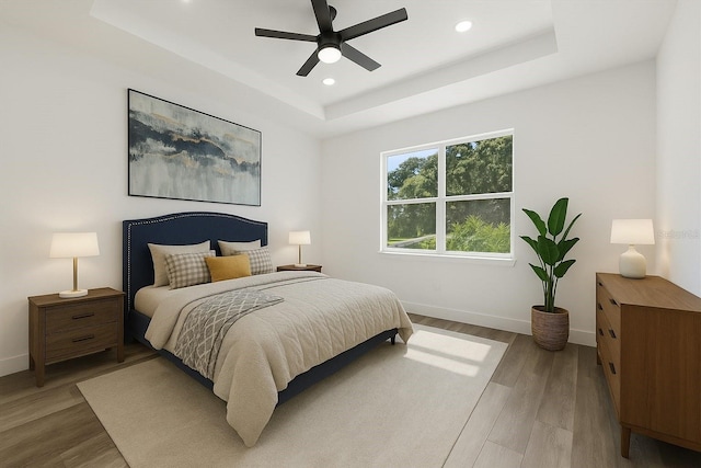 321 Watershore Dr, Leesburg, FL 34748 - bedroom featuring a tray ceiling, recessed lighting, light wood-style floors, and ceiling fan