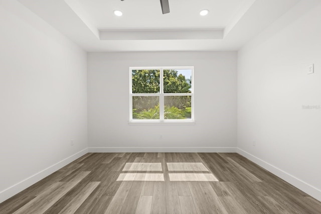 321 Watershore Dr, Leesburg, FL 34748 - spare room with a tray ceiling, wood finished floors, a ceiling fan, and recessed lighting