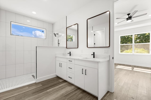 321 Watershore Dr, Leesburg, FL 34748 - bathroom with a walk in shower, double vanity, a ceiling fan, wood finished floors, and recessed lighting