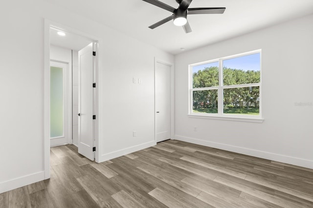 321 Watershore Dr, Leesburg, FL 34748 - unfurnished bedroom featuring wood finished floors and ceiling fan