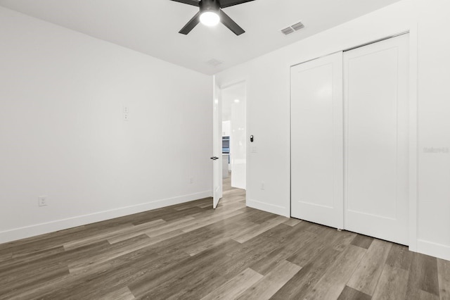 321 Watershore Dr, Leesburg, FL 34748 - unfurnished bedroom featuring wood finished floors, a closet, and ceiling fan