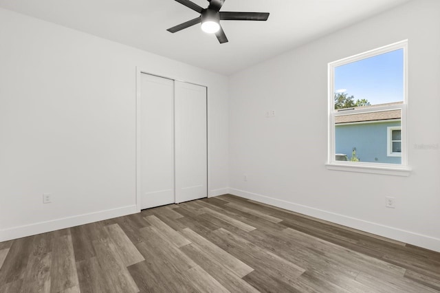 321 Watershore Dr, Leesburg, FL 34748 - unfurnished bedroom featuring wood finished floors, a closet, and ceiling fan