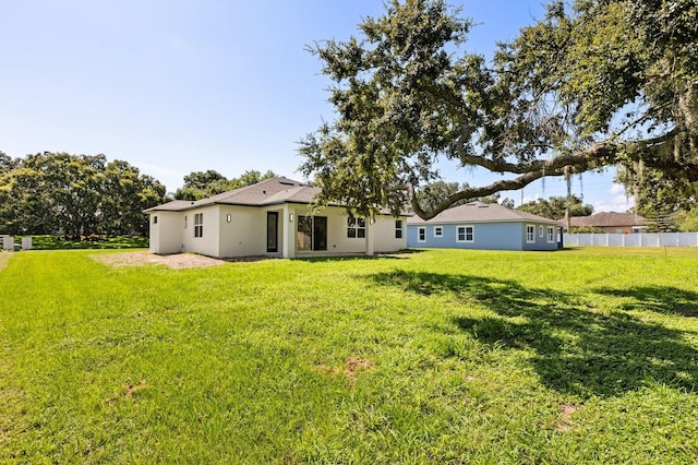 321 Watershore Dr, Leesburg, FL 34748 - rear view of house featuring stucco siding