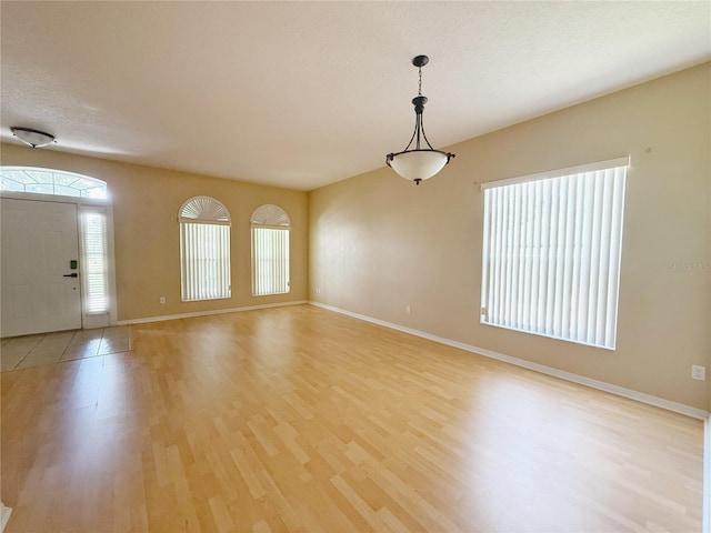 3416 Capland Ave, Clermont, FL 34711 - entrance foyer featuring light wood-style flooring and a textured ceiling