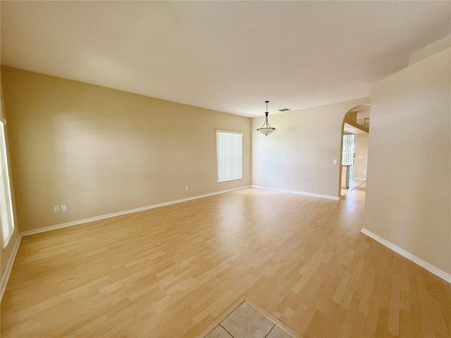 3416 Capland Ave, Clermont, FL 34711 - spare room with arched walkways and light wood finished floors