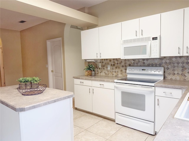 3416 Capland Ave, Clermont, FL 34711 - kitchen with white appliances, tasteful backsplash, light countertops, and arched walkways