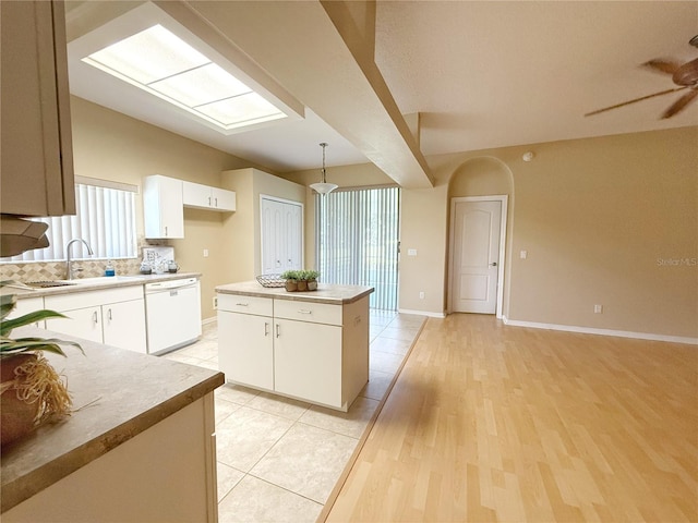 3416 Capland Ave, Clermont, FL 34711 - kitchen with dishwasher, a center island, white cabinets, a ceiling fan, and light countertops